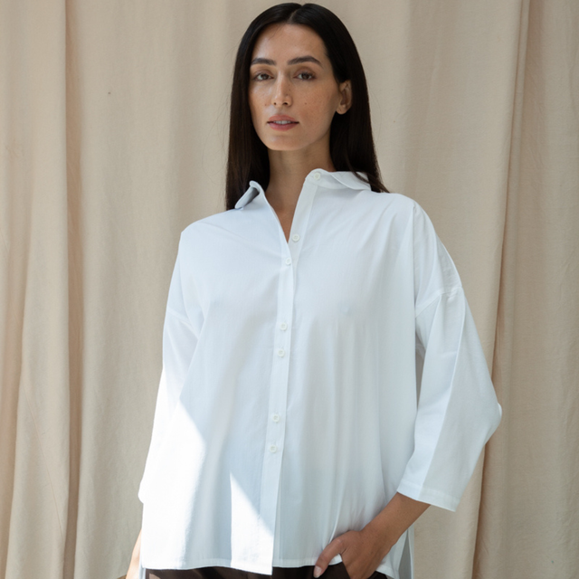 Woman in white organic cotton button down shirt